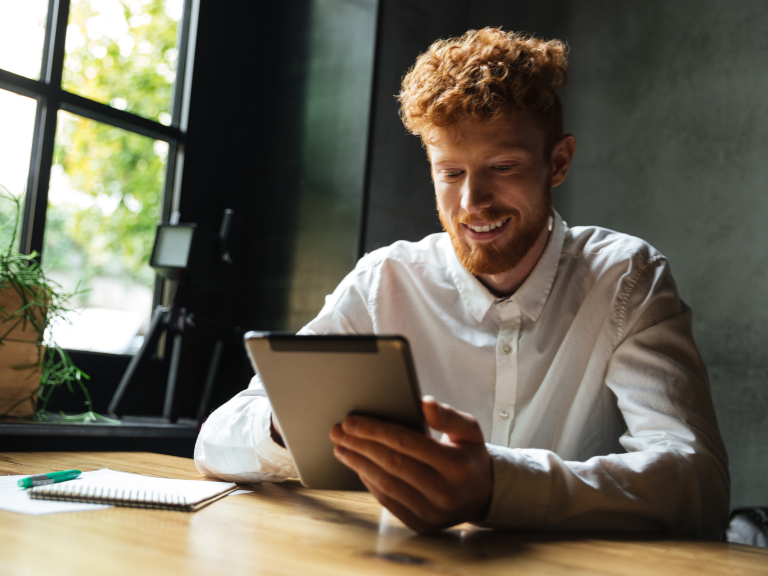 Smiling student using tablet