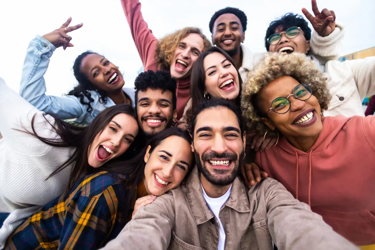 Diverse group of college students smiling together, representing student demographics and campus diversity